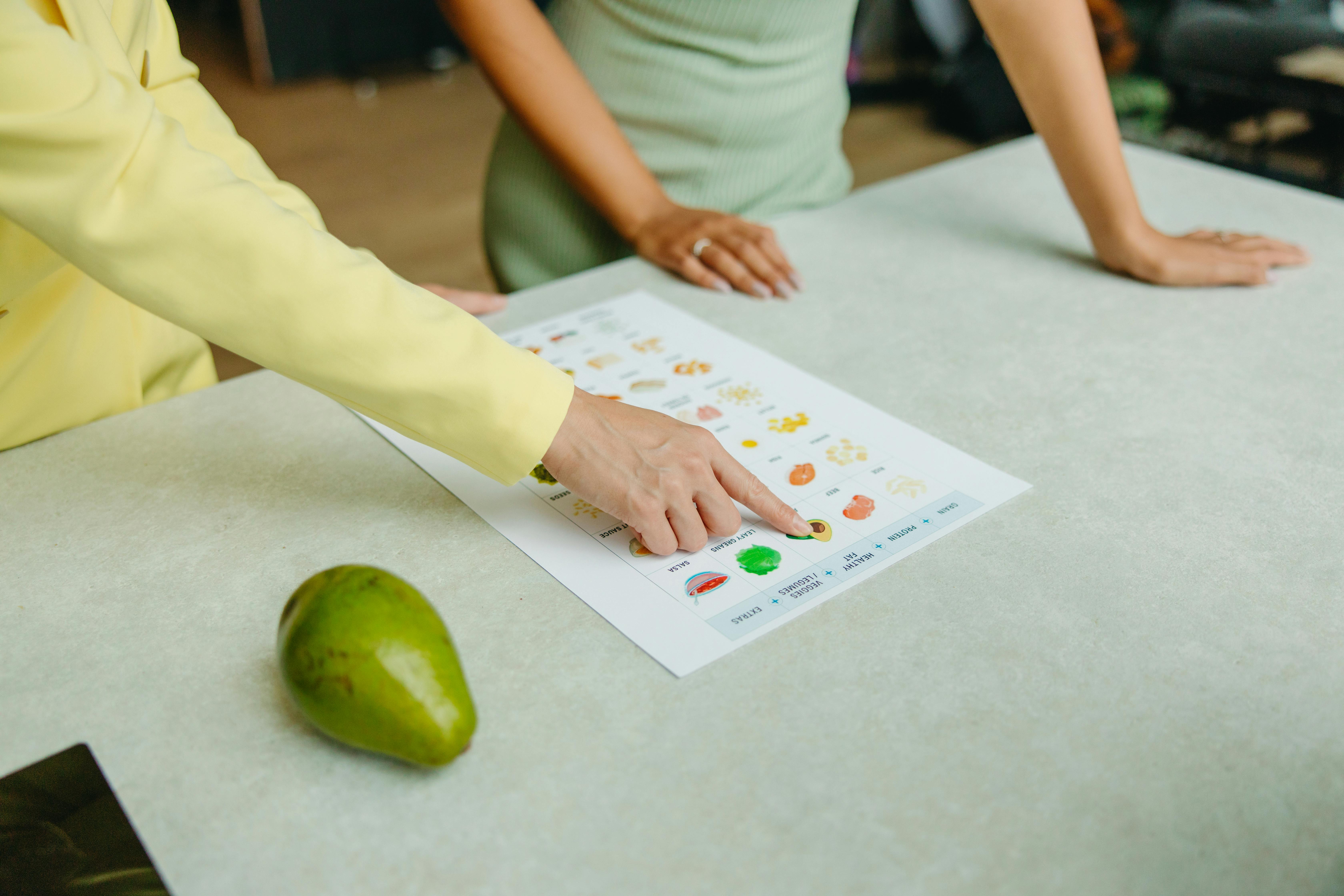 Two people consult a food table